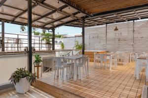 a patio with tables and chairs on a roof at Casa Amanzi Cartagena by Bernalo Hotels in Cartagena de Indias