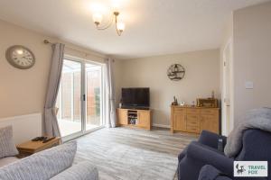 a living room with a couch and a tv at Sarah's House BBQ Parking 10mins To Alton Towers in Rocester