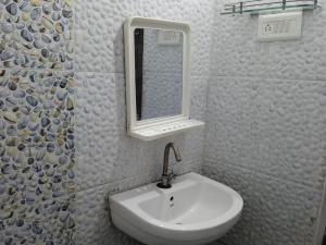 a bathroom with a sink and a mirror at Hotel Kanha Inn in Lucknow