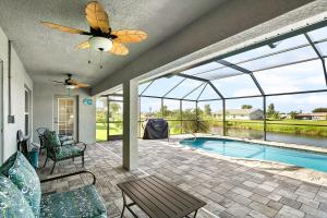 a house with a swimming pool and a ceiling fan at Newley Built Oasis Heated Pool Waterfront retreat in Rotonda West