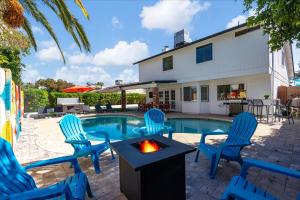 a backyard with chairs and a swimming pool at Epic Mesa Getaway - Pool - Hot Tub - Game Room in Dobson Ranch