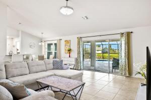 a living room with a couch and a table at Newley Built Oasis Heated Pool Waterfront retreat in Rotonda West