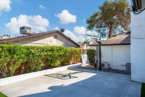 a patio with a bench in front of a house at Epic Mesa Getaway - Pool - Hot Tub - Game Room in Dobson Ranch