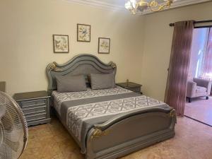 a bedroom with a bed and a chair and a window at Jubaiha Stars in Al Jafr