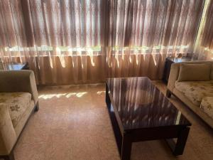 a living room with a couch and a coffee table at Jubaiha Stars in Al Jafr
