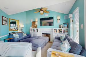 a living room with a couch and a fireplace at Lost Colony #5 in Port Aransas