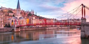 a bridge over a river in a city with buildings at Appartement proche des transports in Villeurbanne