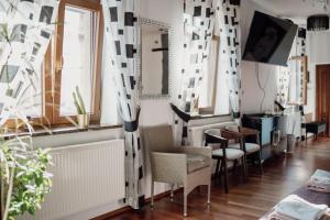 a room with chairs and a table and windows at Apartament w centrum Brzeska 1 in Brzesko