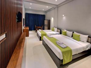 Postel nebo postele na pokoji v ubytování Odyssey Boutique Hotel