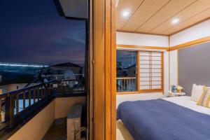 a bedroom with a bed and a balcony at Sakuraya 2 77m 2LDK 8 minutes to Hirokoji Station in Tokyo