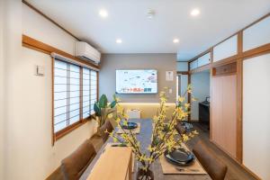 a dining room with a table and a tv at Sakuraya 2 77m 2LDK 8 minutes to Hirokoji Station in Tokyo