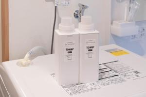 two bottles ofodorizers sitting on top of a bathroom counter at Sakuraya 2 77m 2LDK 8 minutes to Hirokoji Station in Tokyo +81 photos