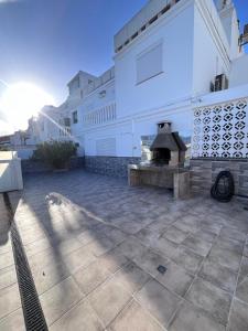 a patio with a pizza oven in front of a building at Malihana- Duplex con vistas y BBQ en Puerto Rico in Mogán
