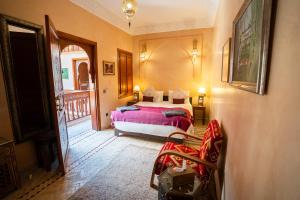 a bedroom with a bed and a balcony at Riad Jamaique - Marrakech in Marrakesh +70 photos