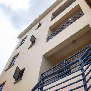 a white building with black windows on the side of it at Abiluxe in Hausa