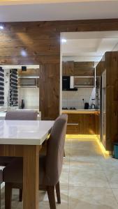 a kitchen with a large white table and chairs at Abiluxe in Hausa