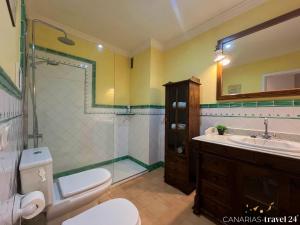 a bathroom with a toilet and a sink and a shower at Versicolor in Los Llanos de Aridane +33 photos