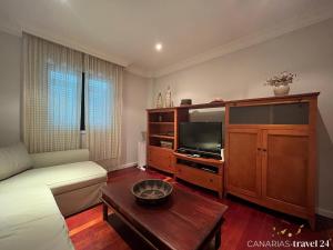 a living room with a bed and a tv at Versicolor in Los Llanos de Aridane