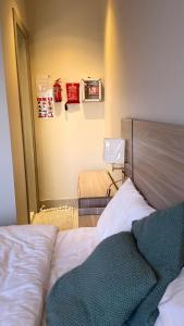 a small bedroom with a bed and a mirror at القصواء in Jeddah +2 photos