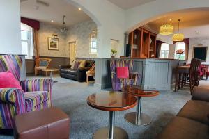 a living room with chairs and a table at Samuel Fox, Bradwell Hope Valley in Bradwell