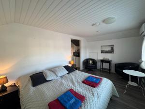 a bedroom with a bed with two pillows on it at Gasthaus Sahanranta in Kuhmoinen
