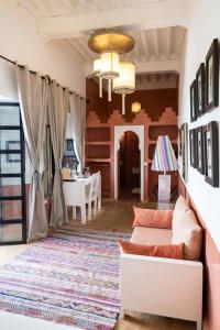 a living room with a couch and a table at Riad Ajmal in Marrakech