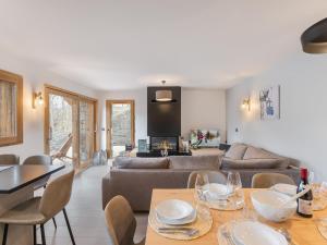 a living room with a couch and a table at Appartement pour 6 avec jacuzzi et vue panoramique - FR-1-570-33 in Saint-Martin-de-Belleville