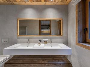 a bathroom with a white sink and a mirror at Chalet Neuf avec Piscine et Sauna à Saint-Martin-de-Belleville - FR-1-570-51 in Saint-Martin-de-Belleville +8 photos