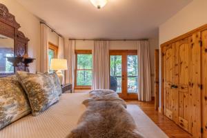 a dog laying on a bed in a bedroom at Altitudes Attitude in Blowing Rock