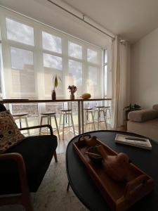 sala de estar con mesa frente a una ventana grande en Casa Paz Lugo, en Lugo