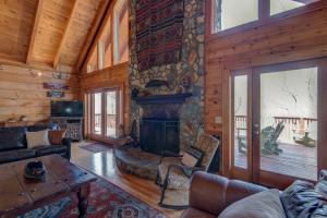a living room with a fireplace in a log cabin at Boles Lodge in Boone