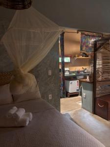 a bedroom with a bed with a mosquito net at Chalé Dona Ramira in Alter do Chao