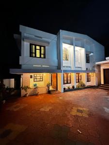 a large white house at night at Fleur Haus in Kappil