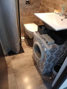 a washing machine in a bathroom next to a sink at STUDIO Perpignan in Perpignan +7 photos