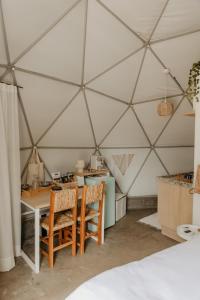 a room with a table and chairs in a tent at Dila's Lodge - 15 min Outlet Catarina São Roque in São Roque