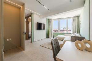 a living room with a couch and a table at Marina Luxury Jacuzzi Suites by PS in Durrës