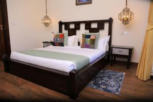 a bedroom with a large bed in a room at Pyramid Hotels & Resorts in Debre Zeyit +5 photos