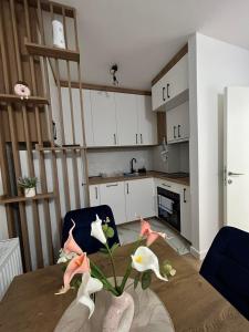 a kitchen with a table with pink birds on it at Apartman Maja in Budžak