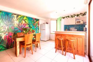 a kitchen with a table and chairs and a refrigerator at Ocean View 2BR Apt at Resort, 1 Block to the Beach in Puerto Vallarta