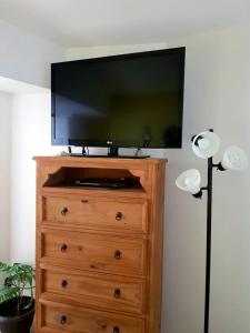 a flat screen tv on top of a dresser at Ocean View 2BR Apt at Resort, 1 Block to the Beach in Puerto Vallarta