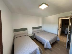 a room with two beds in a room at Casa Collado Apartmento 2A in San Vicente