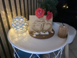 a table with a hat and flowers on it at Bellevue T1 cozy avec piscine et panorama alpin - proche du lac in La Motte-Servolex +14 photos