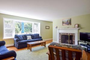 a living room with a couch and a fireplace at 1 6 mi to Nauset Beach in Orleans