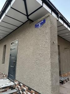 a blue street sign on the side of a building at Begzod's Loft House in Samarkand