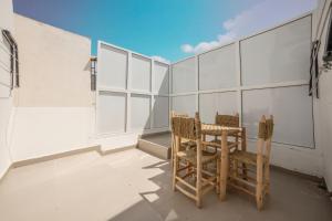 a balcony with two chairs and a table on a building at Jaws Wave ESSAOUIRA in Ghazoua