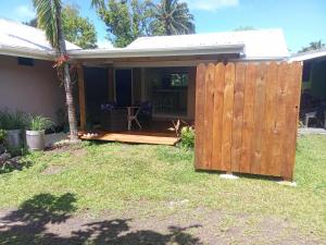 a wooden fence in front of a house at Rei-Ris Place in Ngatangiia