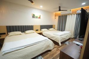 Postel nebo postele na pokoji v ubytování Hotel Ambika