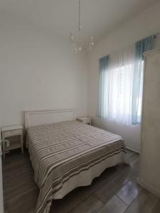a bedroom with a bed in a white room at Chiaro di Luna - Appartamento Luna Piena in Paestum
