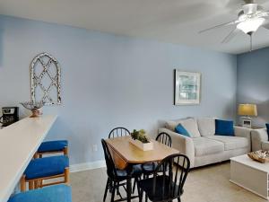 a living room with a couch and a table at The Village #514 in Blue Mountain Beach