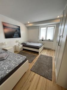 1 dormitorio con 2 camas y nevera en Ferienwohnung in Kaunitz bei Wessels, en Verl